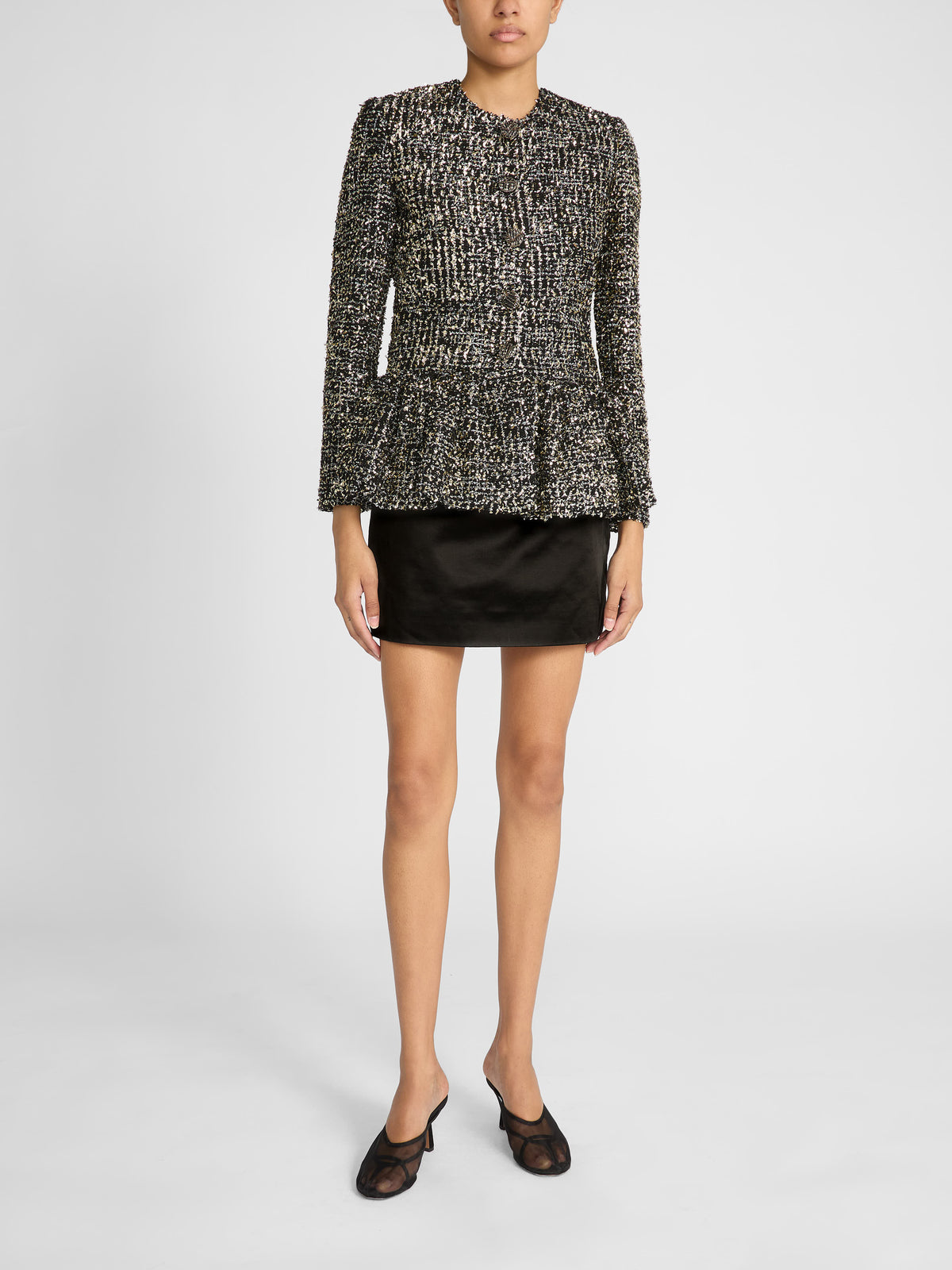 Woman wearing Liberowe black tweed Raja jacket buttoned with tailored trousers
