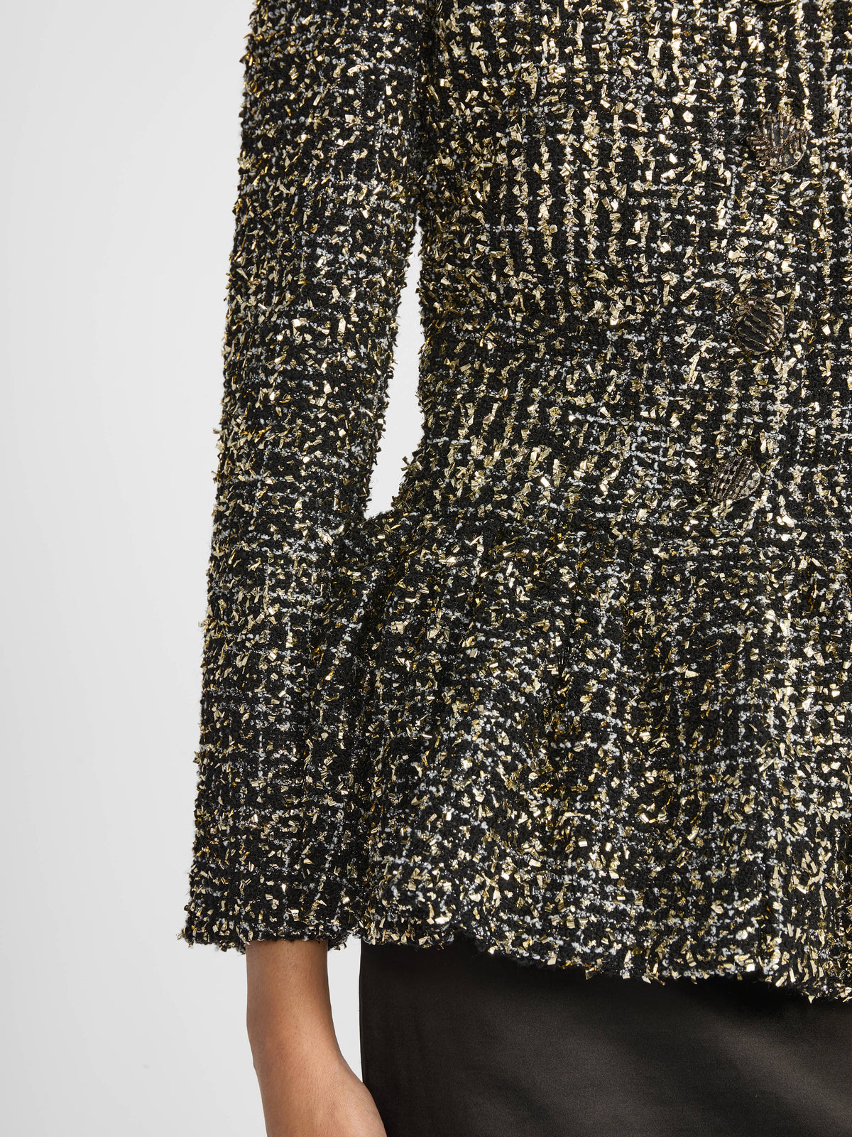 Woman wearing Liberowe black tweed Raja jacket buttoned with tailored trousers