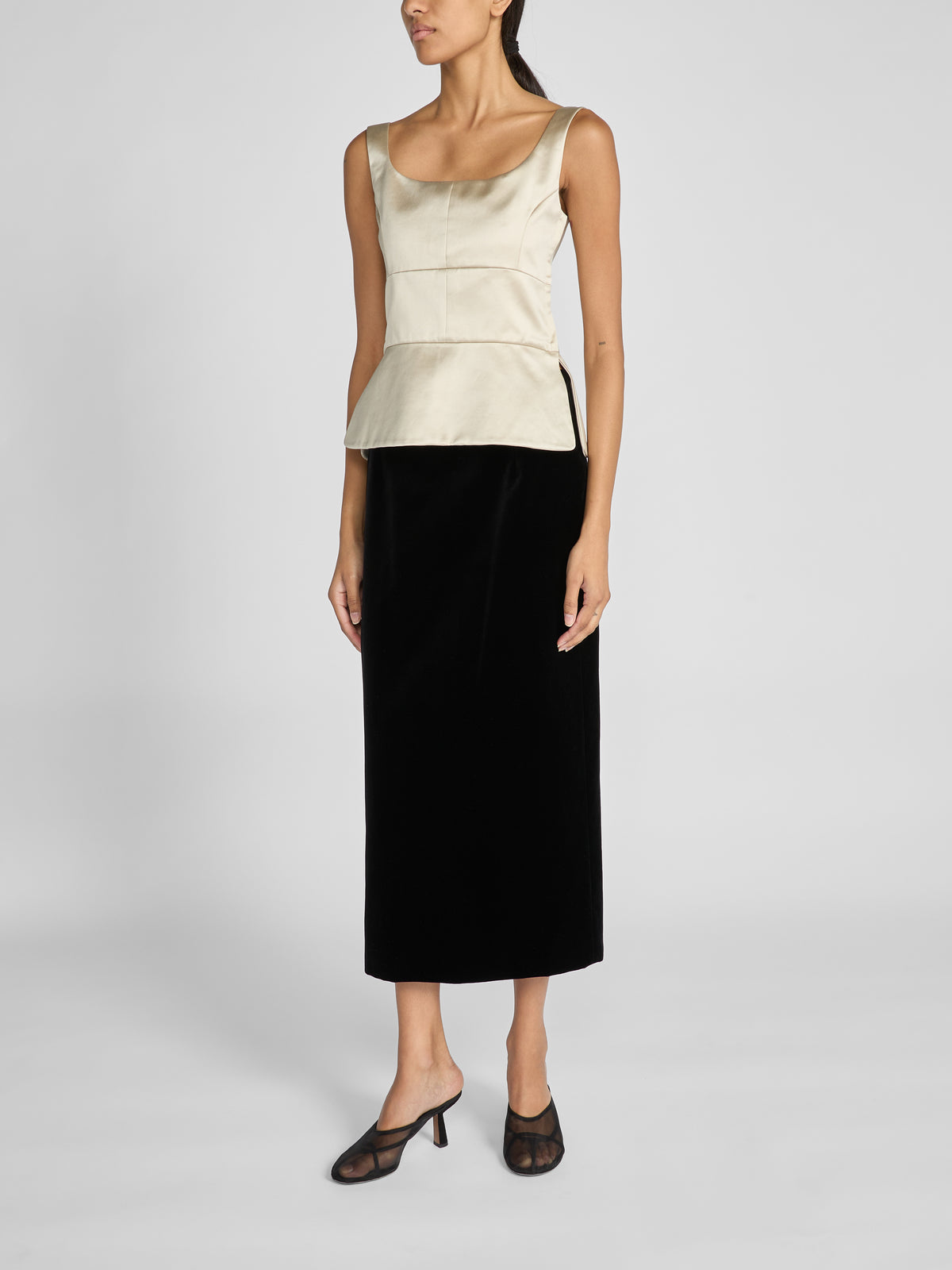 Crafted from luxurious black cotton velvet, the Rory Skirt is a high-waisted tailored midi skirt designed in a sleek column silhouette for a flattering shape before falling straight to mid-calf.