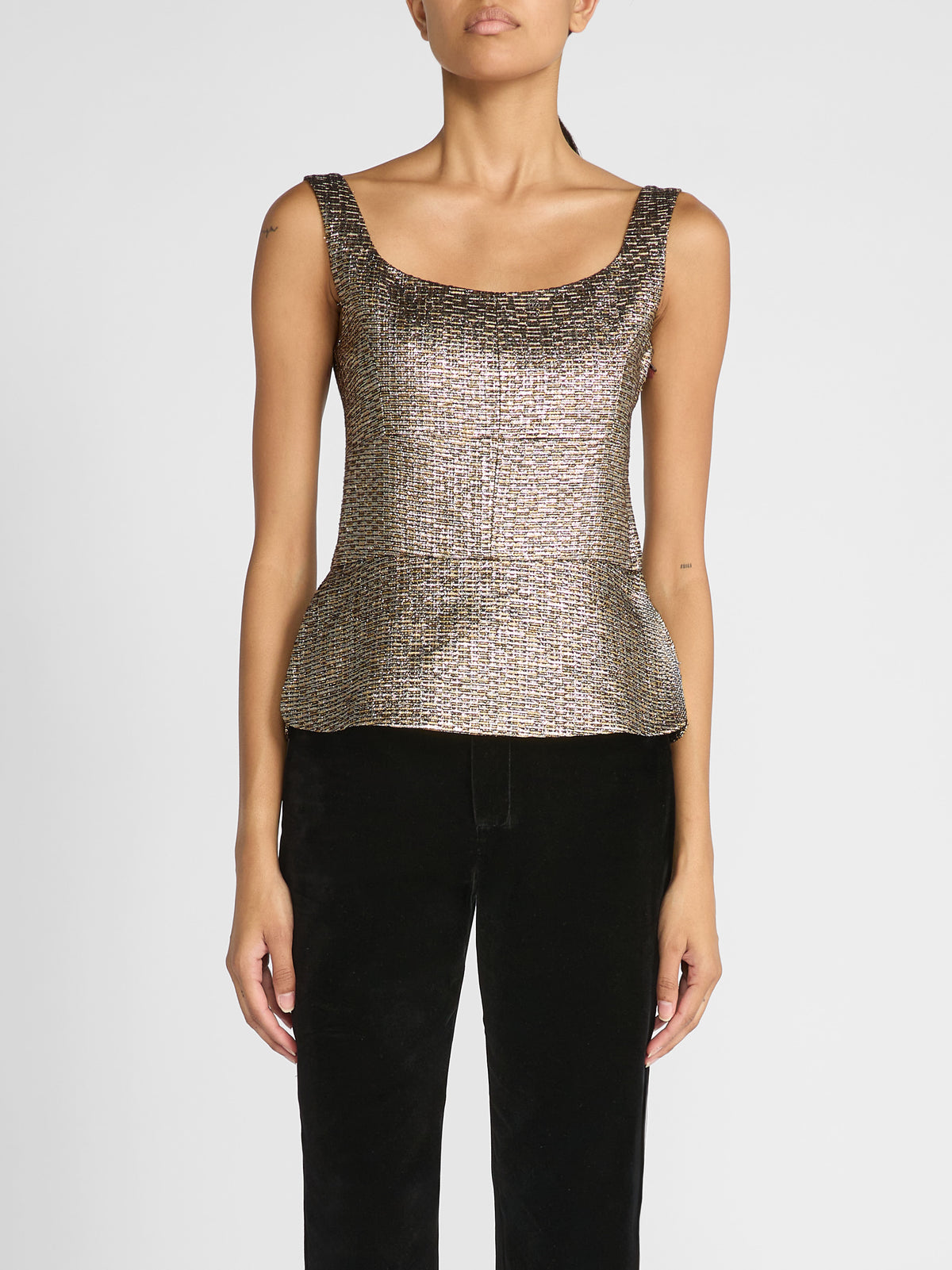 Crafted in luxurious mixed gold jacquard, this fitted sleeveless top features a structured, bustier-inspired bodice with defined bust seams for a sophisticated, feminine finish.