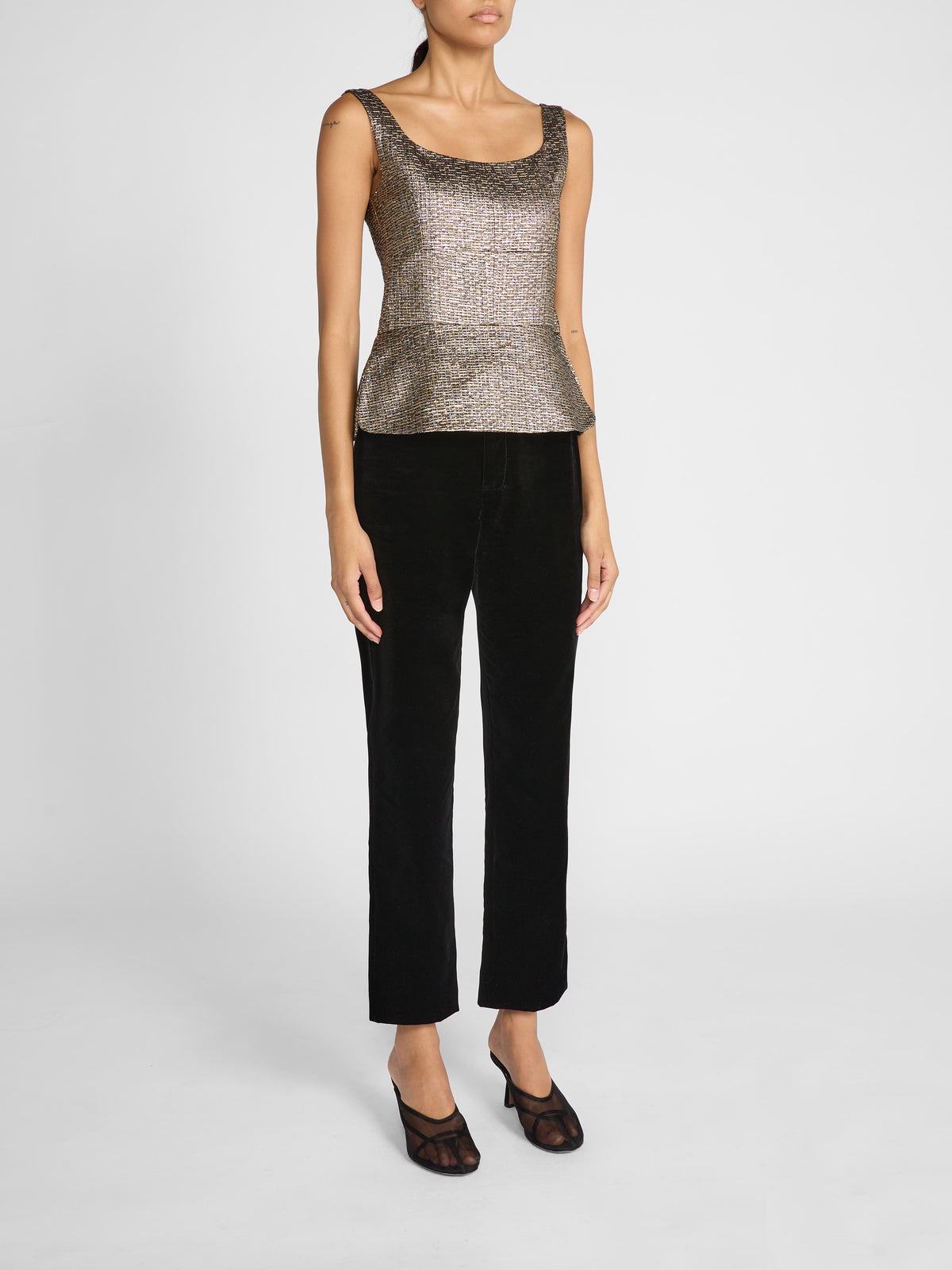 Crafted in luxurious mixed gold jacquard, this fitted sleeveless top features a structured, bustier-inspired bodice with defined bust seams for a sophisticated, feminine finish.