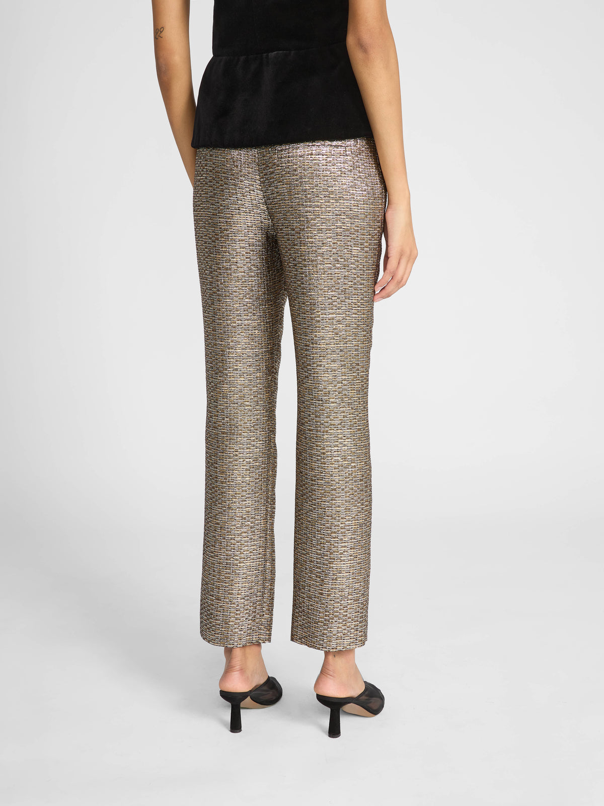Crafted in textured jacquard, these slim-fit trousers feature an intricate metallic-speckled pattern in sophisticated gold tones.