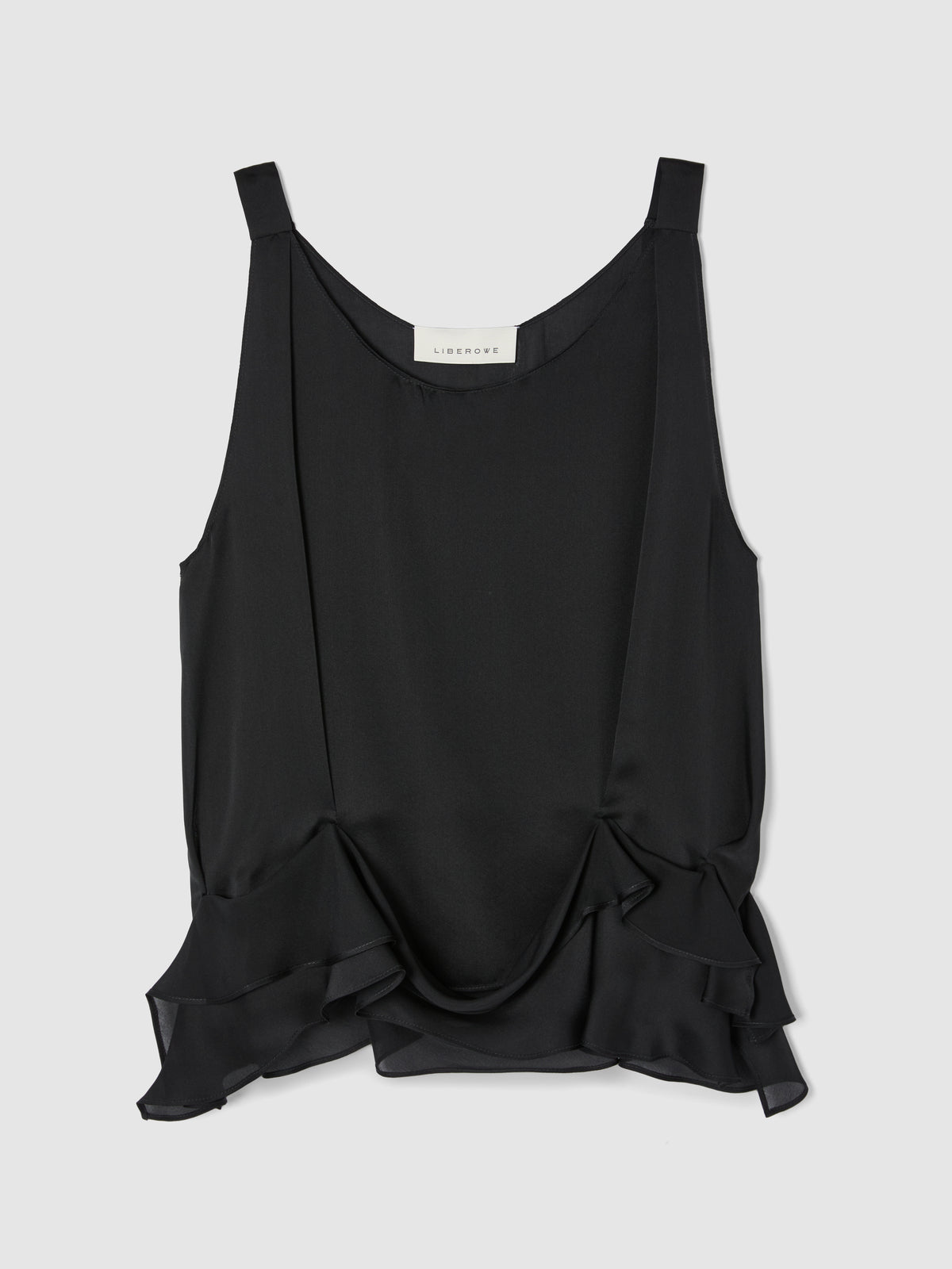 Crafted from fluid black silk, this sleeveless top features a softly draped bodice and elegant scoop neckline, creating a graceful, feminine silhouette.