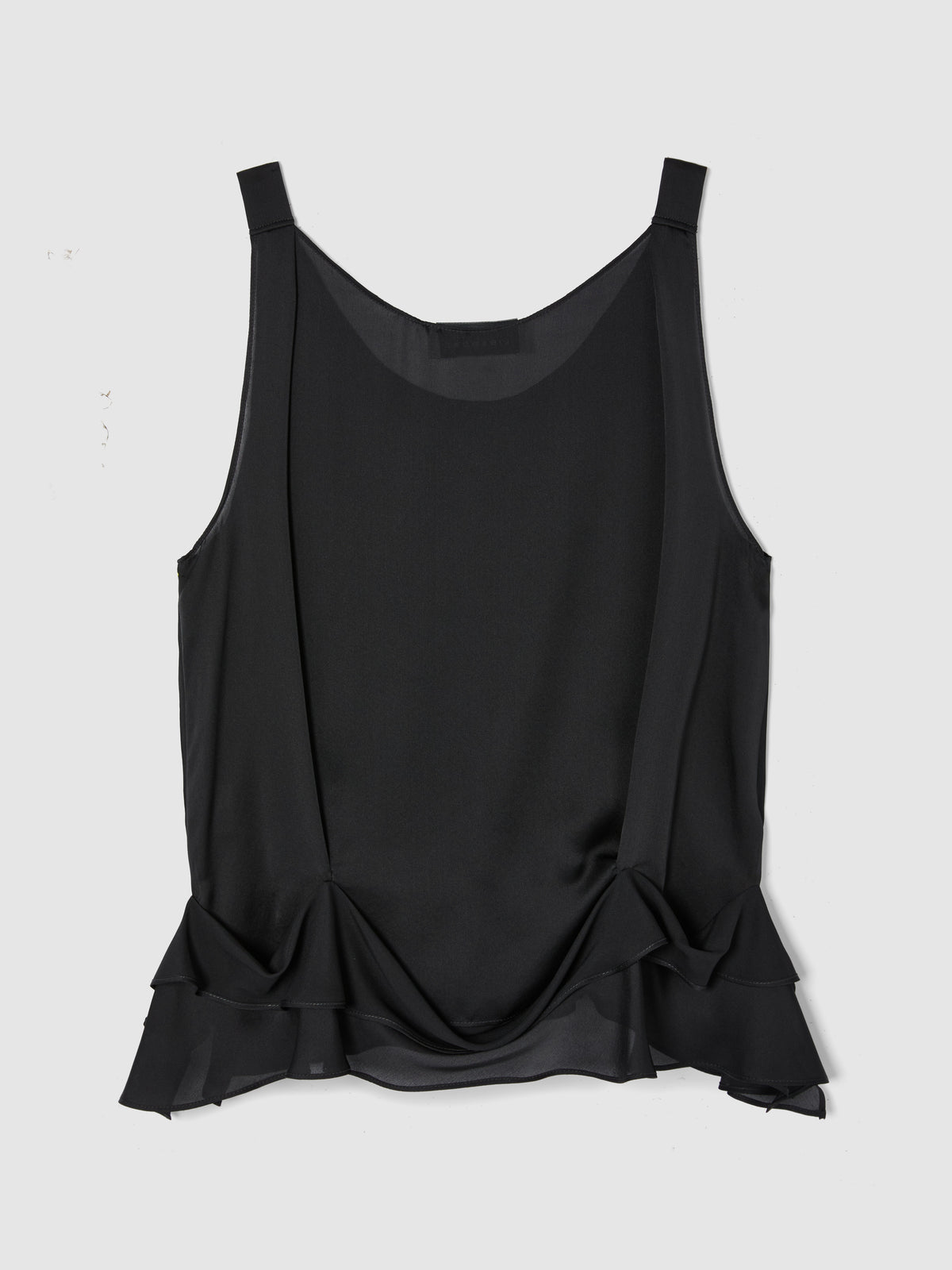 Crafted from fluid black silk, this sleeveless top features a softly draped bodice and elegant scoop neckline, creating a graceful, feminine silhouette. flat from the back