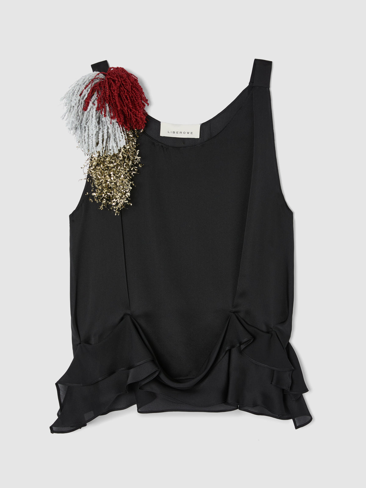 Crafted from fluid black silk, this sleeveless top features a softly draped bodice and elegant scoop neckline, creating a graceful, feminine silhouette. shown with fringe brooch